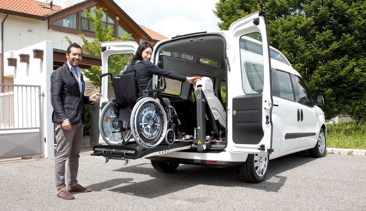 utente in carrozzina sta entrando nel Doblò grazie al sollevatore che fa parte dell'allestimentoallestimento