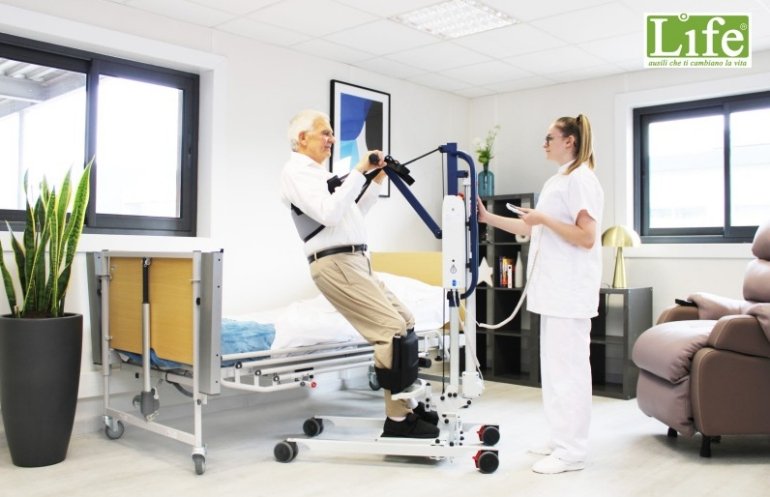 assistente aiuta un uomo anziano a mettersi in piedi utilizzando il verticalizzatore elettrico disabili